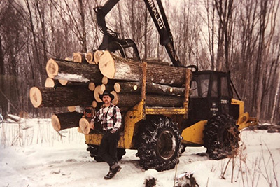 Young Steve Mihalko stands in front of his harvester.