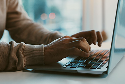 Shot of an businessman working on his laptop in the office