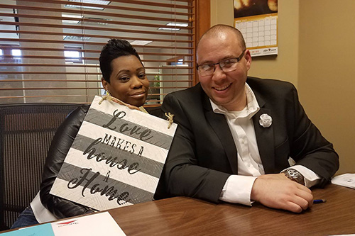 Joshua Johnson and his wife Michelle celebrating the closing on their first home.