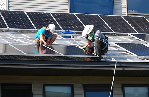 People working on solar panels
