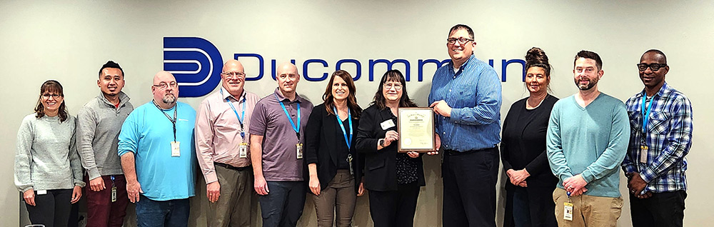 Ducommum was presented with Gov. Tony Ever's Exemplary Employer Award on Tuesday, Oct. 24, at its Appleton office during National Disability Employment Awareness Month. Pictured, from left, Chris Grunske, HR Generalist; Lee Thao, HR Generalist; Dan Mielke, Production Manager; Darren McDougal, Sr. Supply Chain Manager; Jeff Loritz, Operations Manager; Beth Kerrigan, Sr. HR Business Partner; Delora Newton, DVR Administrator; Eric Dudek, Performance Center Director; Heather Prosek, Proposals Supervisor; Adam Rindfleisch, Recruiting and Branding Supervisor; and Santiago Onuchuku, Sr. Test Engineering Manager.