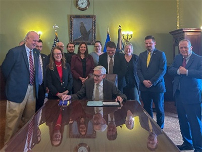 People sitting around table with Wisconsin Governor, Tony Evers
